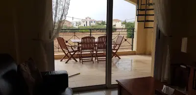 a patio with a table and chairs on a balcony at Mazotos Panoramic Village in Mazotos
