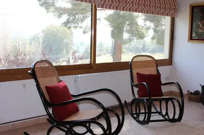 two chairs sitting in a room with a window at Villa in Moniatis in Moniatis