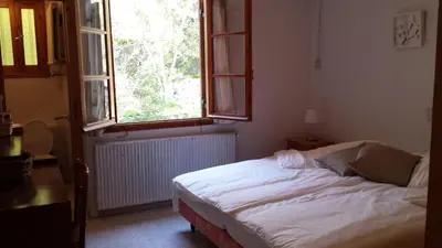 a bed in a room with a large window at Villa in Moniatis in Moniatis
