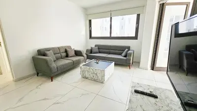 a living room with two couches and a coffee table at Modern Wellness Escape Apartment with Optional Health Transformation Retreat in Larnaka