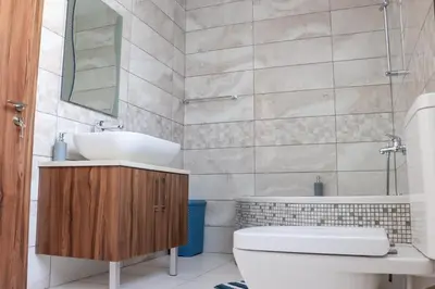a bathroom with a sink and a toilet and a tub at Marios Villa in Larnaka