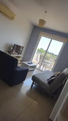 a living room with a chair and a large window at Obv 5201 in Pyla