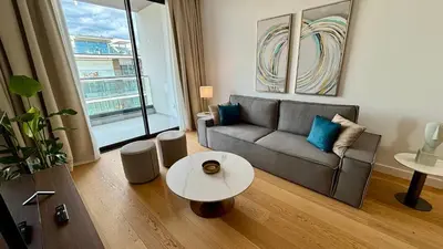 a living room with a couch and a table at Bali Residence Apt by TrulyCyprus in Limassol