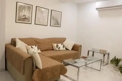 a living room with a couch and a table at Spacious Apartment, NEAR PINIKOUDES BEACH in Larnaka