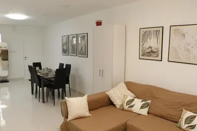 a living room with a couch and a dining room at Spacious Apartment, NEAR PINIKOUDES BEACH in Larnaka
