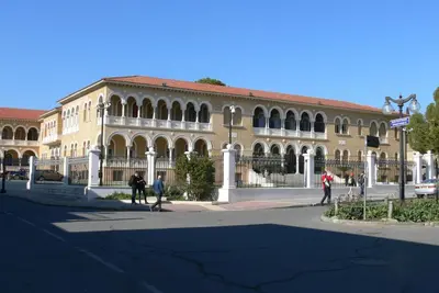 a large building with people walking in front of it at Alkinoos Studio in Nicosia