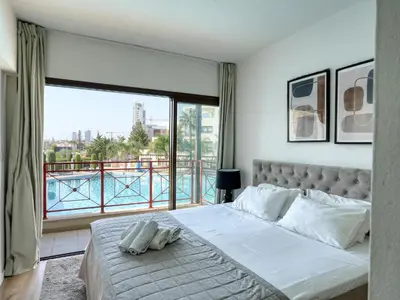 a bedroom with a bed and a large window at Aqua House Valentino in Limassol