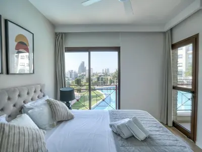 a bedroom with a bed and a large window at Aqua House Valentino in Limassol