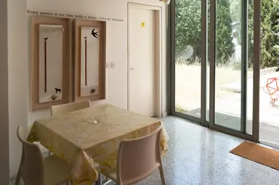 a dining room with a table and chairs and sliding glass doors at ResArt Traditional House in Nicosia