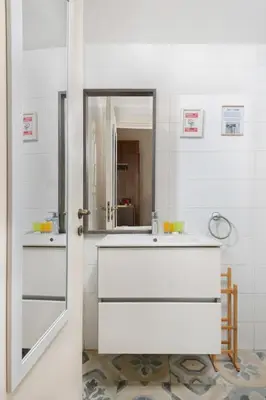 a bathroom with a white sink and a mirror at Klokkari Stays - Cozy Stay City Center By Platform 357 in Nicosia