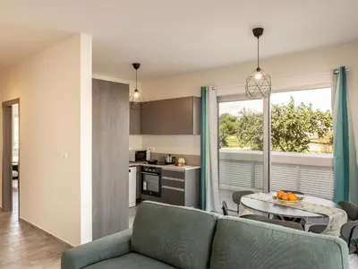 a living room with a couch and a table at Mythical Blue Apartment 004 in Protaras