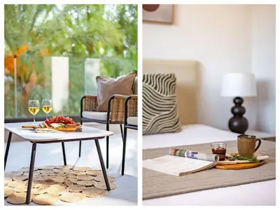 a living room with a table with food and glasses of wine at Sanders Breeze Limassol in Limassol