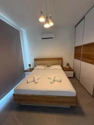 a bedroom with a bed with two towels on it at Theo luxury Napa villa in Ayia Napa