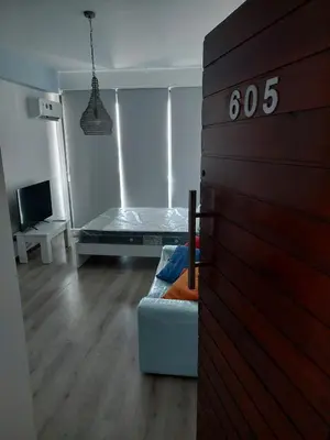 a room with a bed and a table in it at Seafront City Center Studio in Limassol