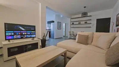 a living room with a couch and a flat screen tv at STAY Limdream Apartment in Limassol