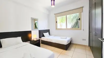 a hotel room with two beds and a window at Palmvibes Villa With Private Pool in Paralimni