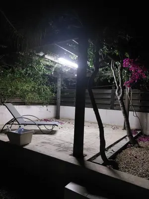 a view of a garden with a tree and a bench at Danitsea villa with privat pool in Psematismenos