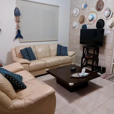 a living room with two couches and a coffee table at Danitsea villa with privat pool in Psematismenos