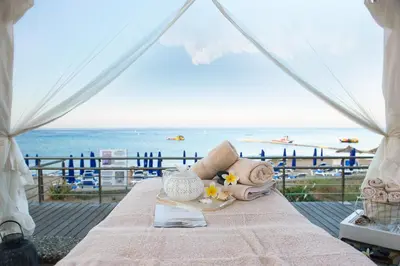 a table with a view of the beach at Vrissiana Boutique Beach Hotel in Protaras