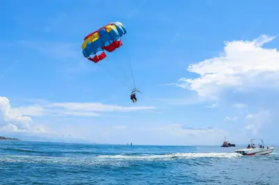 a person para sailing in the ocean with a parachute at Tsokkos Gardens Hotel in Protaras