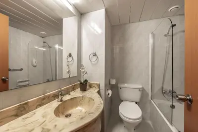 a bathroom with a sink and a toilet and a shower at Antigoni Hotel in Protaras