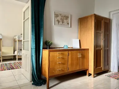 a room with a wooden cabinet and a dresser at OLD Hostel in Limassol