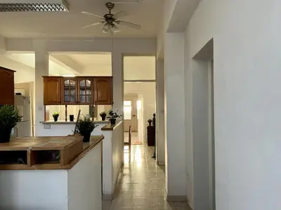 a kitchen with white walls and a ceiling fan at OLD Hostel in Limassol