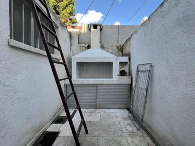 a ladder leaning against a building with a garage at OLD Hostel in Limassol