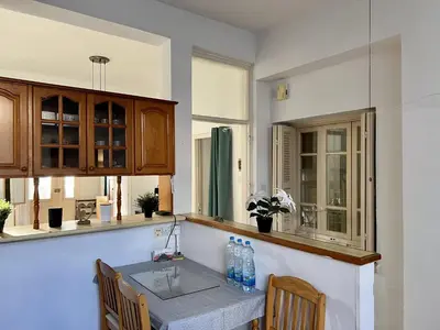 a kitchen with a table and chairs in a kitchen at OLD Hostel in Limassol