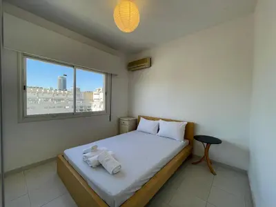 a small bedroom with a bed with a window at Central Comfort in Nicosia - Orfeos By Platform 357 in Nicosia