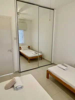 a room with two beds and a large mirror at Central Comfort in Nicosia - Orfeos By Platform 357 in Nicosia