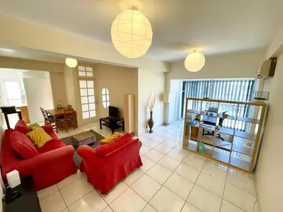 a living room with two red chairs and a table at Central Comfort in Nicosia - Orfeos By Platform 357 in Nicosia
