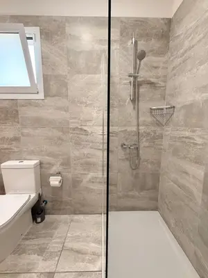 a bathroom with a shower with a toilet and a sink at Bungalow House Kiti, seaside in Kiti