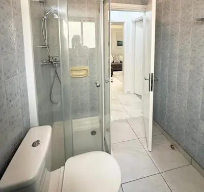 a bathroom with a shower and a toilet in it at Melia Suites in Limassol