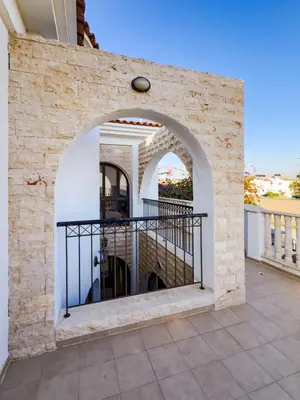 a stone wall with an archway on a balcony at Beachfront Villa with Private Pool and Exotic Fruit Garden in Pyla