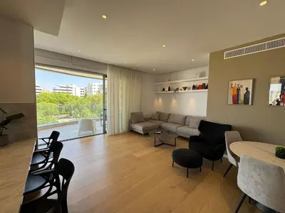 a living room with a couch and a table at WealthyStays Parkside Residence in Nicosia
