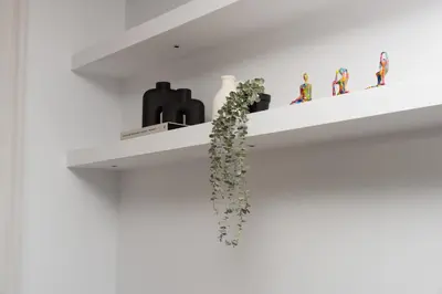 a white shelf with a plant on it at WealthyStays Parkside Residence in Nicosia
