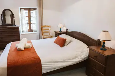 a bedroom with a bed with two towels on it at Ariadni Cottage in Vasa