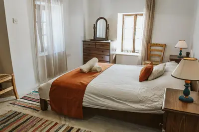 a bedroom with a bed with two pillows on it at Ariadni Cottage in Vasa