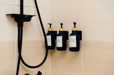 a group of four bottles of soap in a shower at Spitaki 2 BDR Apartment with Pool and Close Proximity to Beach in Paralimni