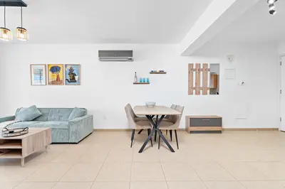 a living room with a couch and a table at Spitaki 2 BDR Apartment with Pool and Close Proximity to Beach in Paralimni