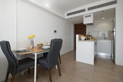a kitchen and dining room with a table and chairs at Apartment Josephine - Beachfront in Protaras