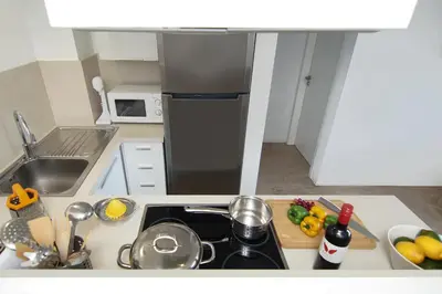 a kitchen with a sink and a black refrigerator at Apartment Josephine - Beachfront in Protaras