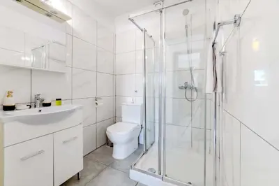 a white bathroom with a shower and a toilet at Napa Centro Apartment in Ayia Napa