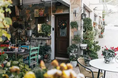 a building with a table and chairs and a door at Kyperounta Retreat in Kyperounda