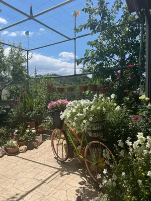 a bike parked in a garden with flowers at Kyperounta Retreat in Kyperounda