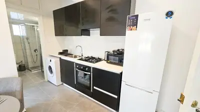 a kitchen with a white refrigerator and a sink at La Magenta Apartments in Pyla
