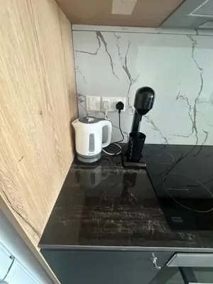 a black counter top with a coffee maker on it at Luxurious two bedroom apartment with roof garden in Kato Lakatamia
