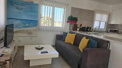 a living room with a couch and a table at STAY Villa Harsha in Ayia Napa
