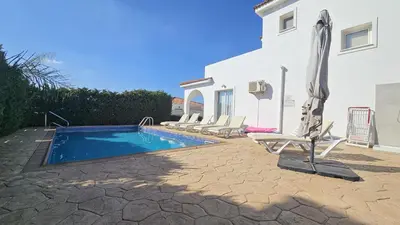 a villa with a swimming pool and a house at STAY Villa Harsha in Ayia Napa